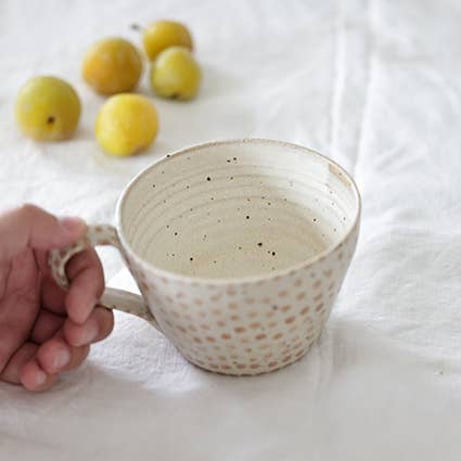 Coffee mug with light brown polka dot pattern